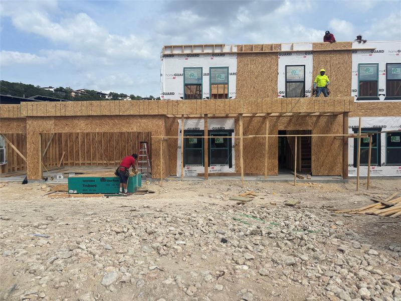 Property under construction featuring a framed structure with visible windows and sheathing