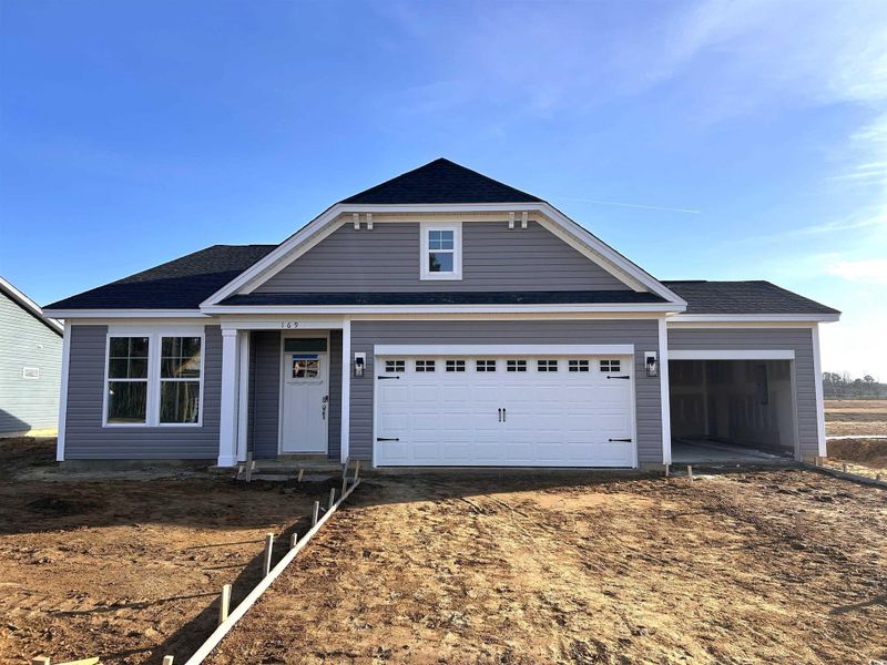 View of front of house with a garage, roof with shingles, and driveway