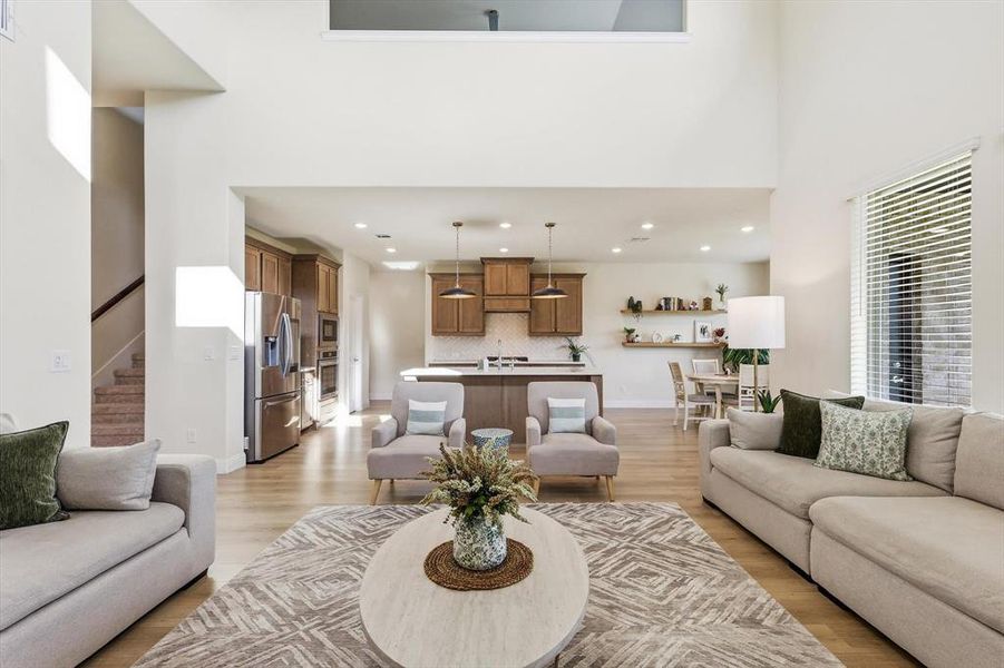 Open-concept Family area with soaring ceilings looking into the gorgeous super upgraded kitchen