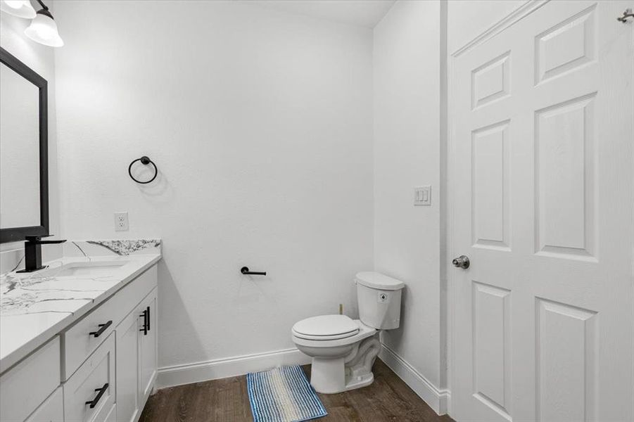 Bathroom with vanity and dark wood-style floors Bathroom with vanity and dark wood-style floors