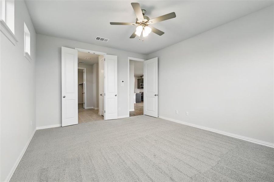 Unfurnished bedroom featuring carpet flooring and ceiling fan Unfurnished bedroom featuring carpet flooring and ceiling fan