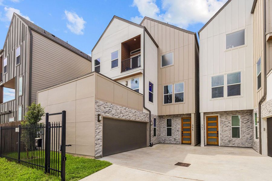 Modern exterior featuring a spacious two-car garage and low-maintenance design. Modern exterior featuring a spacious two-car garage and low-maintenance design.