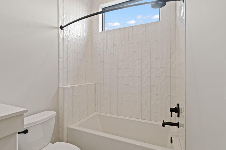 Shared bathroom area with shower / tub combination.