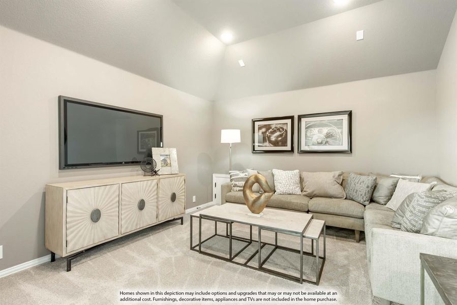 Living room with vaulted ceiling, sectional sofa, wall-mounted TV, and neutral carpet flooring