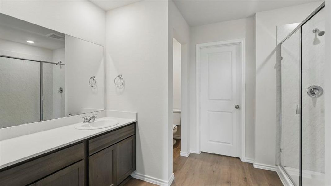 Contemporary bathroom featuring a single vanity with dark wood-finish cabinetry, a white countertop, and an oval undermount sink