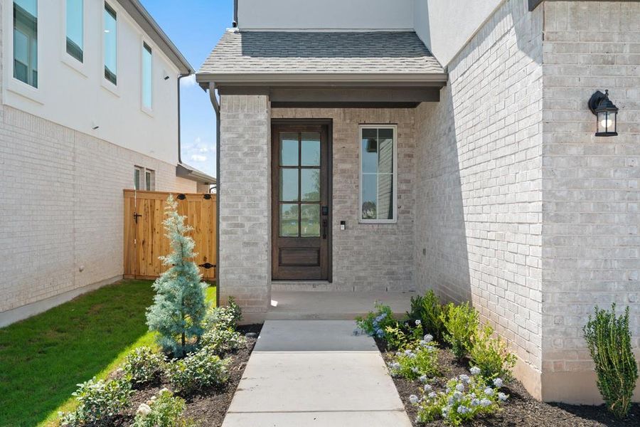 Front exterior of a new home in Flora, Hutto, TX, highlighting curb appeal (Image 20).