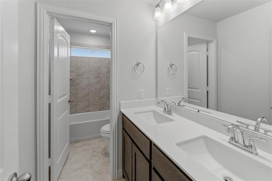 Double vanity with white countertops and undermount sinks