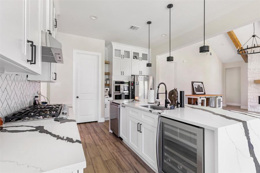 Kitchen Features a Large Island with Built-In Wine Fridge