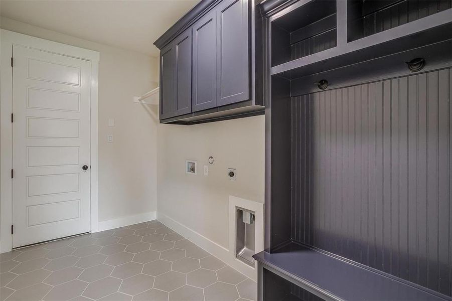 Laundry room with cabinets, tile flooring, hookup for an electric dryer, and hookup for a washing machine