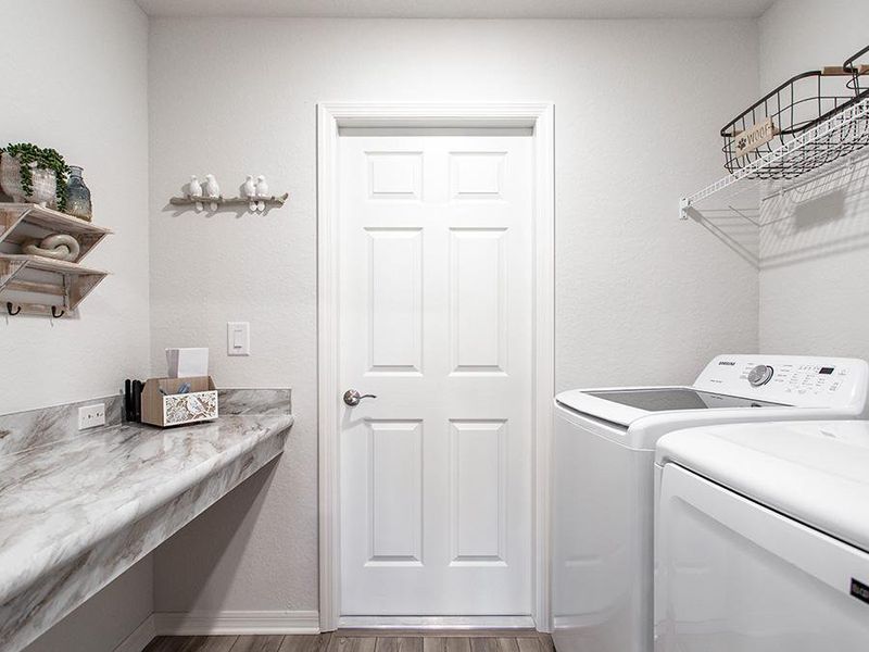 Dedicated laundry room with drop zone at the garage entry - Remy home plan by Highland Homes