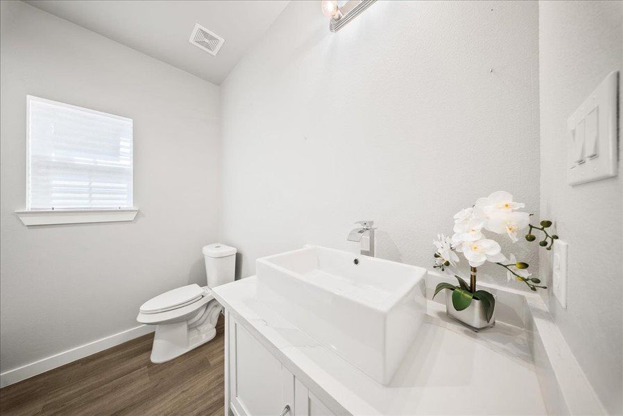 Half bath with vanity and dark wood-style flooring Half bath with vanity and dark wood-style flooring