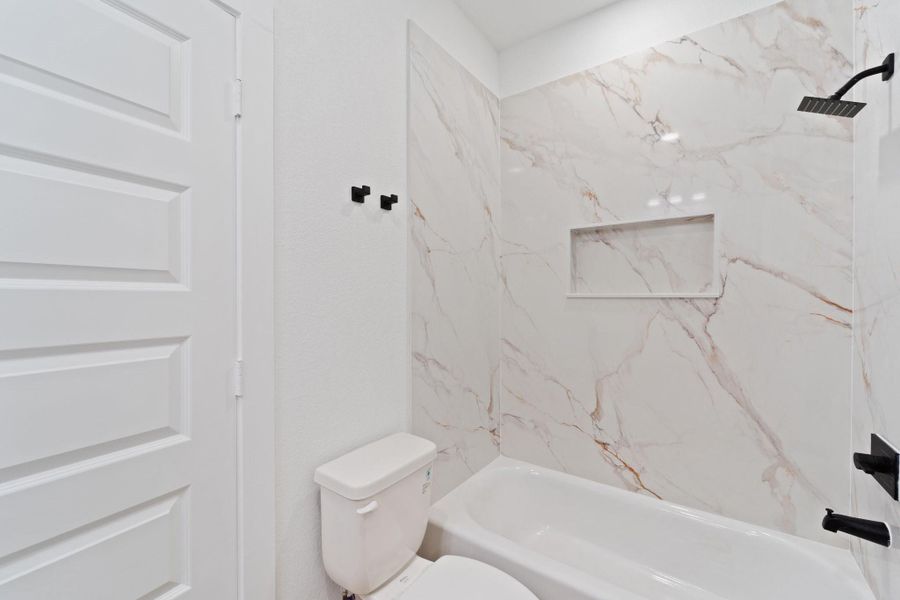 This primary bathroom is highlighted by an amazing shower/tub combo with tile walls.