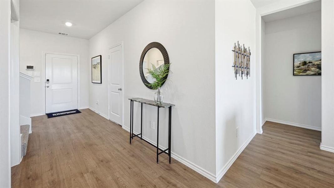 Foyer entrance with light wood-type flooring and baseboards Foyer entrance with light wood-type flooring and baseboards