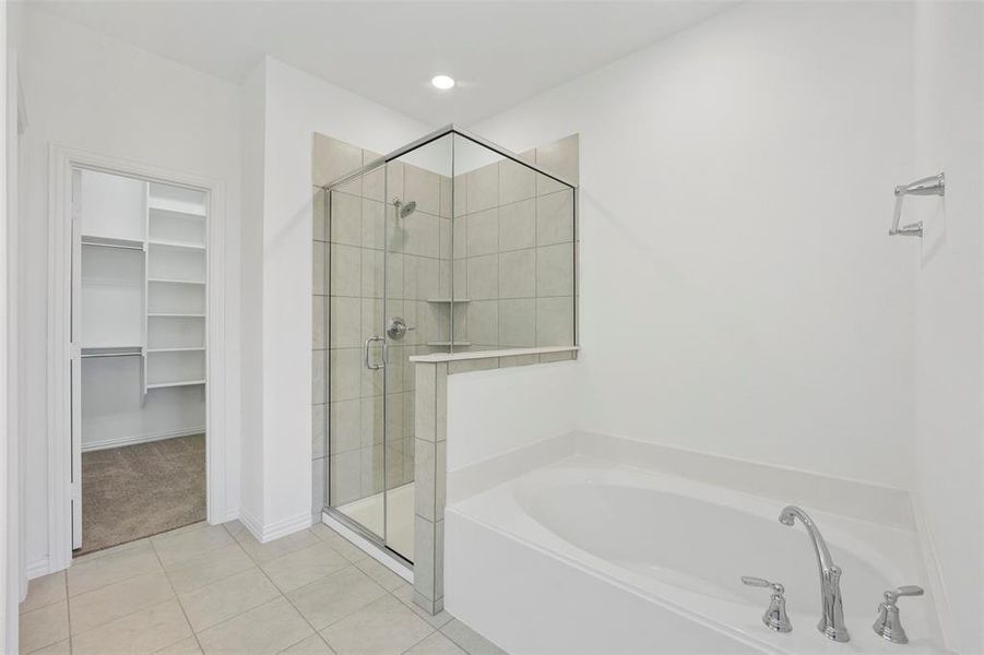 Bathroom with tile patterned floors and separate shower and tub