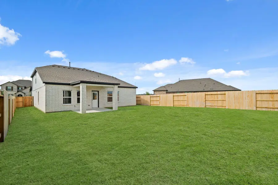 Front exterior of a new home in Sunterra, Katy, TX, highlighting curb appeal (Image 2). Front exterior of a new home in Sunterra, Katy, TX, highlighting curb appeal (Image 2).