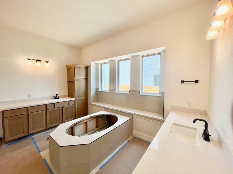Full bath with two vanities and a garden tub Full bath with two vanities and a garden tub