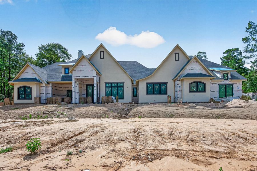 One and a half story resting on a 1.5 acre lot featuring a horseshoe driveway leading to the 4 car garage.