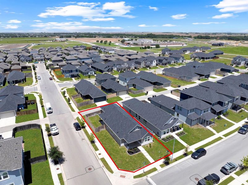 Aerial perspective of suburban area with property parcel outlined Aerial perspective of suburban area with property parcel outlined