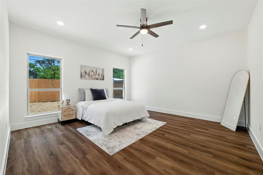 Bedroom with dark wood-style flooring, recessed lighting, and ceiling fan