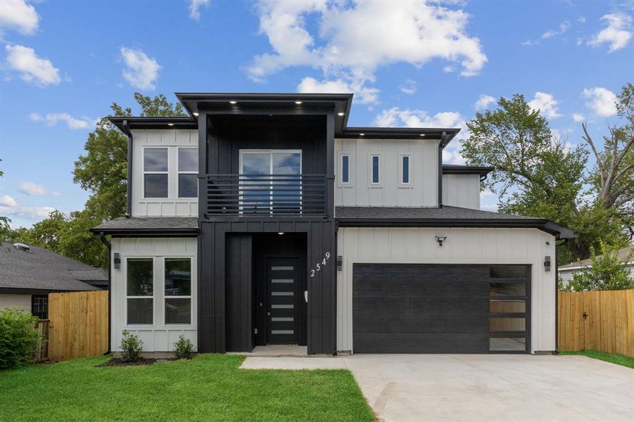 Contemporary house with a balcony, a garage, and a front yard