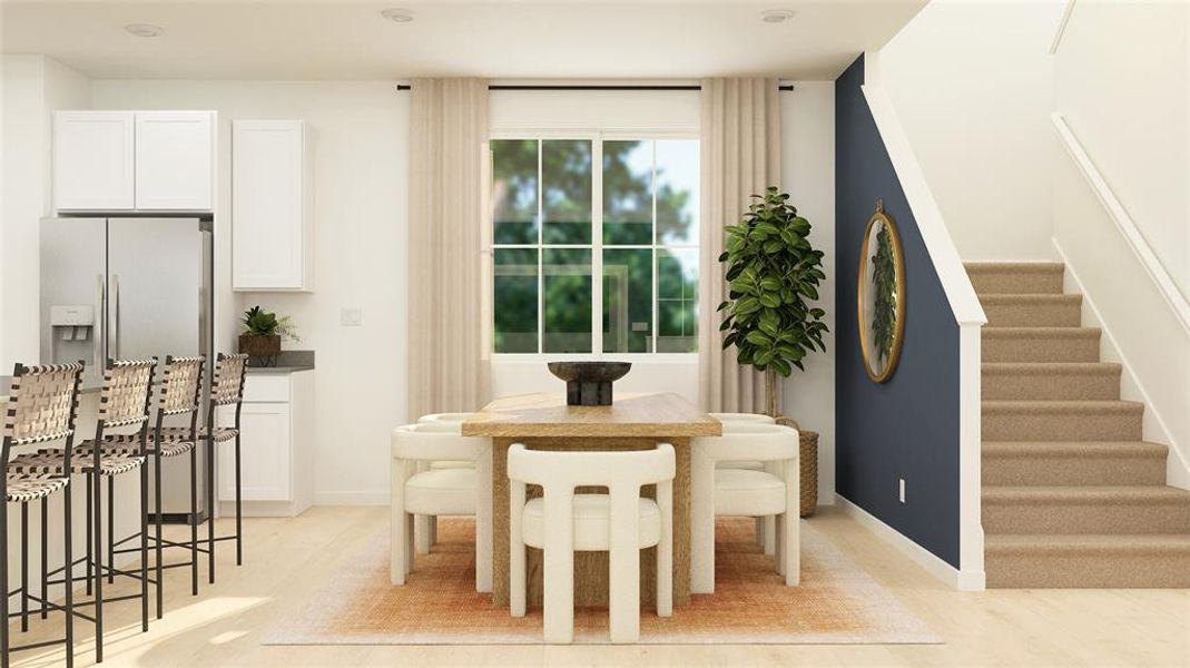 Dining space with stairs and light wood-style flooring