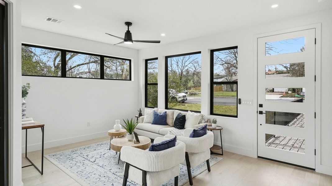 Sitting room featuring a ceiling fan, recessed lighting, and light wood-style flooring