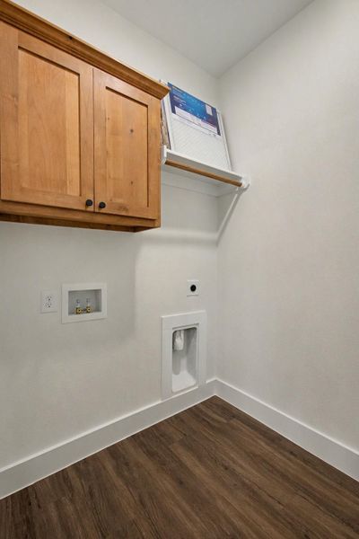 Laundry room featuring electric dryer hookup, cabinet space, dark wood-style flooring, and hookup for a washing machine