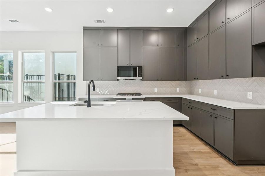 Huge island and modern cabinetry.