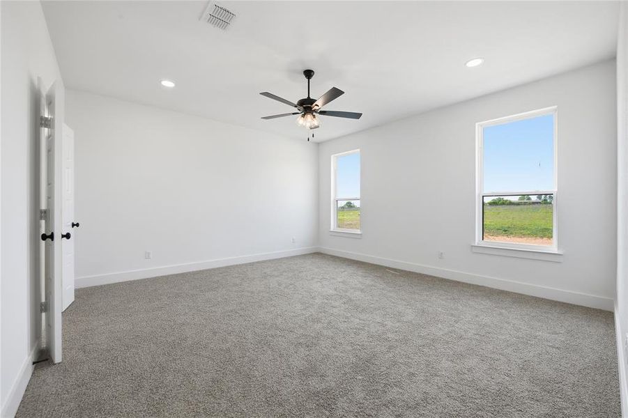 Carpeted empty room featuring recessed lighting and ceiling fan Carpeted empty room featuring recessed lighting and ceiling fan