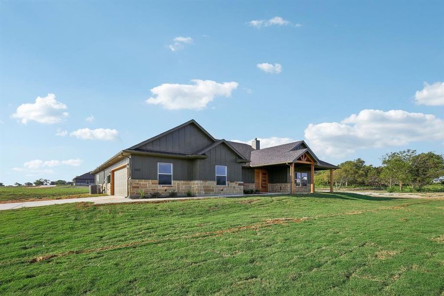 View of front of house with a garage and a front yard