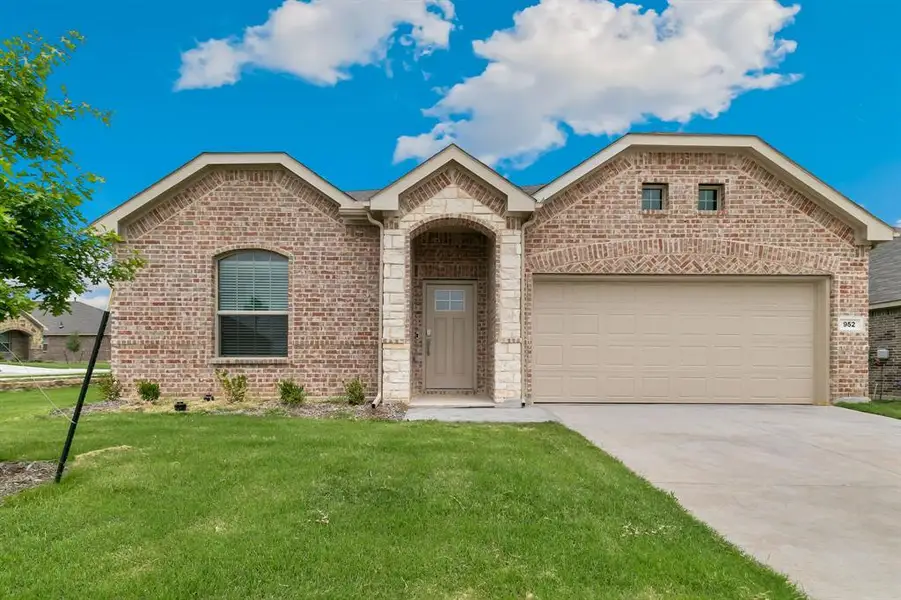View of front of house with a front lawn and a garage