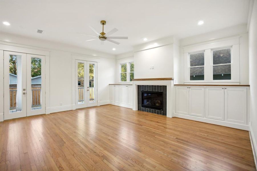 The family room in this plan is very spacious. Two sets of double doors lead out to the back porch. Double windows over the generous storage built-ins draw in sunlight from the East.