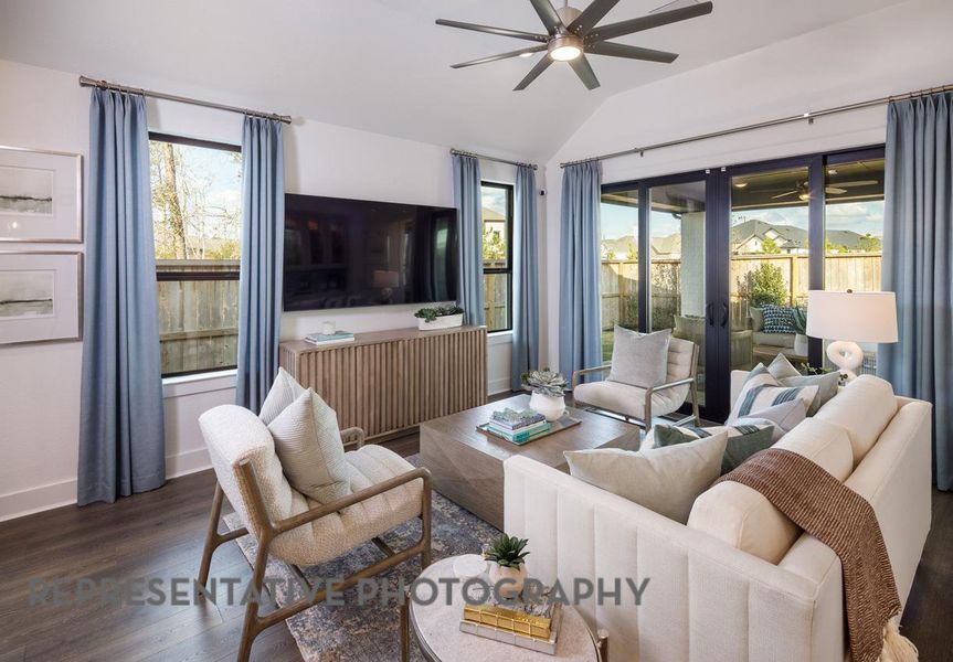 Living area featuring a ceiling fan, wood finished floors, healthy amount of natural light, lofted ceiling, and french doors Living area featuring a ceiling fan, wood finished floors, healthy amount of natural light, lofted ceiling, and french doors