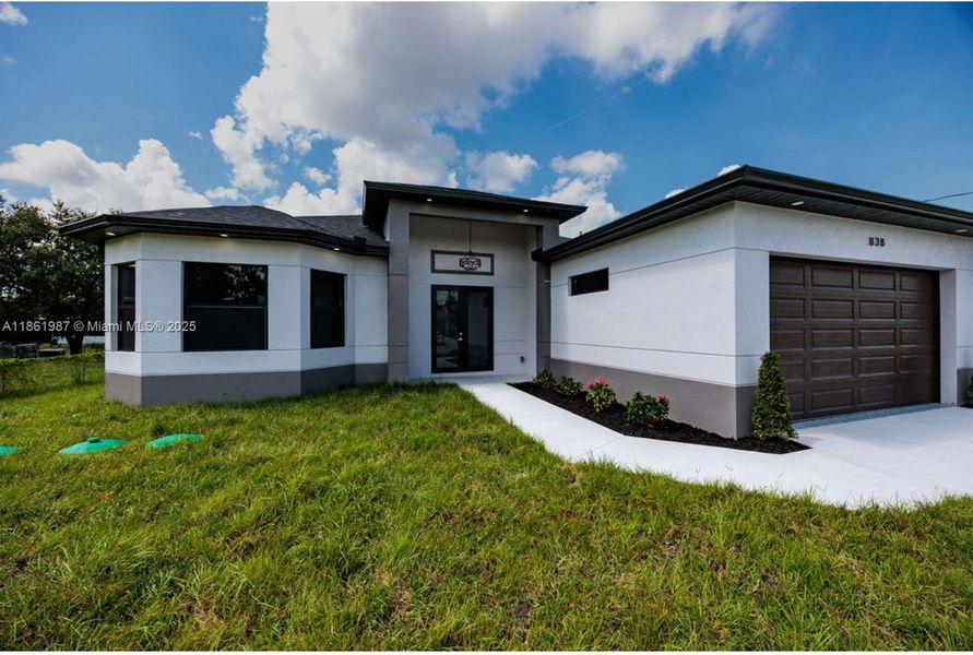 Front exterior of a new home in , Lehigh Acres, FL, highlighting curb appeal (Image 15). Front exterior of a new home in , Lehigh Acres, FL, highlighting curb appeal (Image 15).