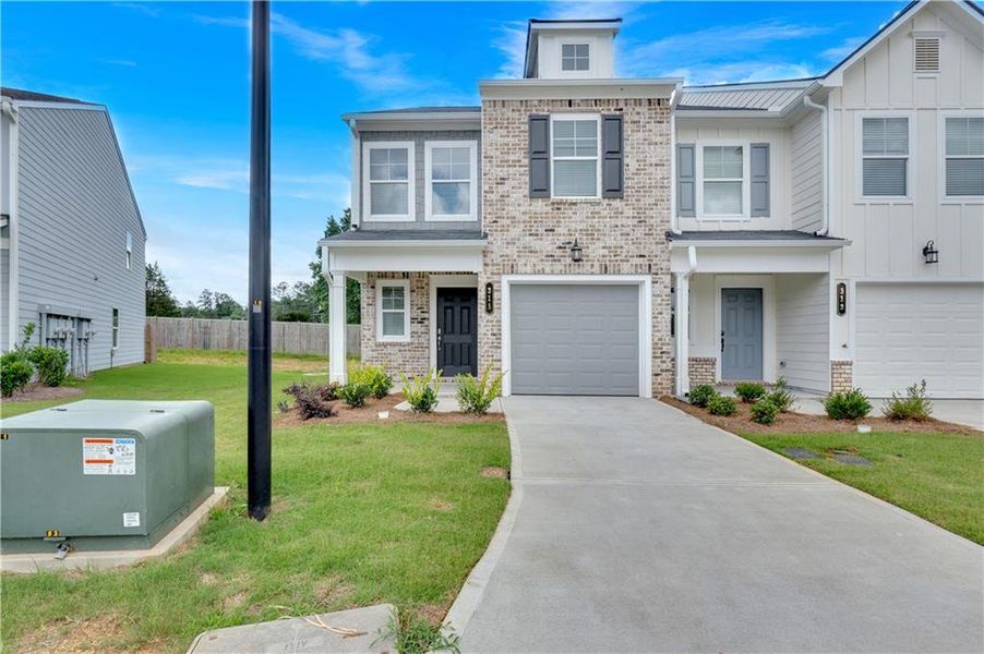 Front exterior of a new home in Village Green, Adairsville, GA, highlighting curb appeal (Image 26).