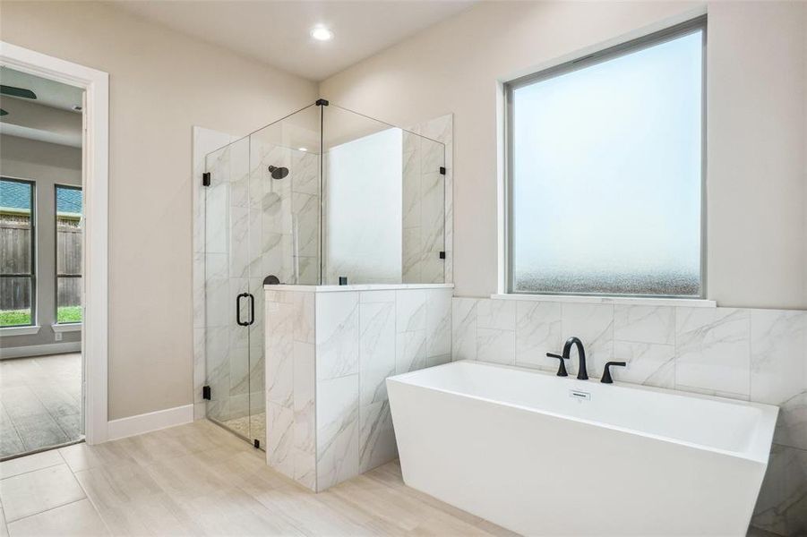 Beautiful freestanding tub with large opaque window are just one of the features of this amazing bathroom! Beautiful freestanding tub with large opaque window are just one of the features of this amazing bathroom!