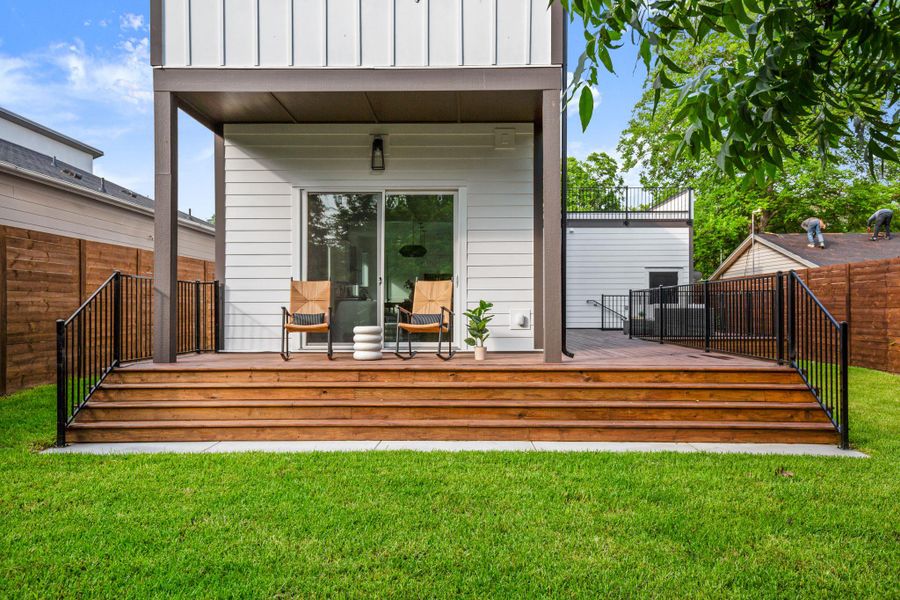 Wooden terrace with fence and a yard