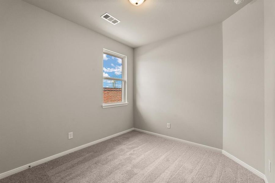 Your secondary bedroom features plush carpet, fresh paint, closet, and a large window that lets in plenty of natural lighting.