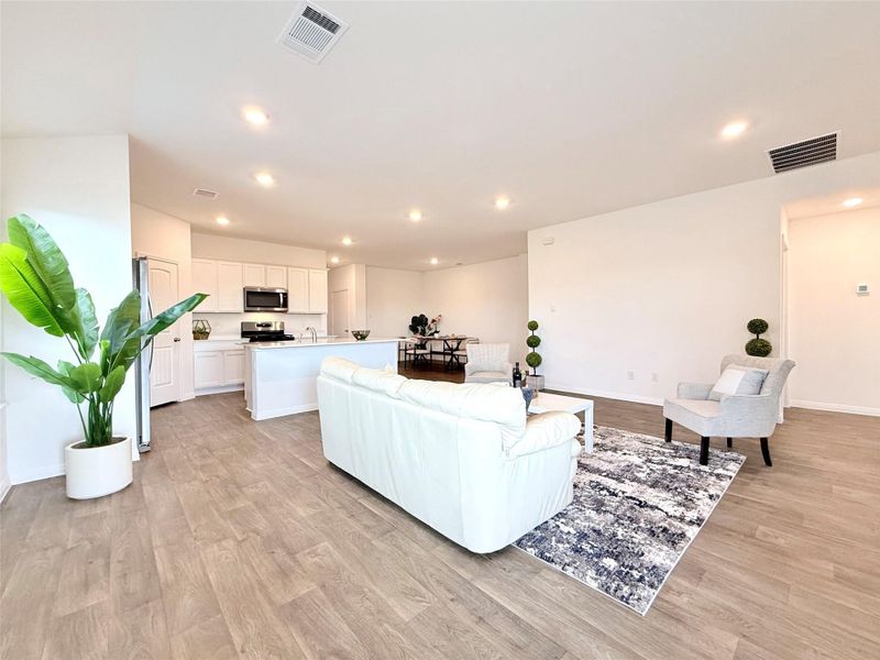 Living room featuring light wood-style flooring and recessed lighting Living room featuring light wood-style flooring and recessed lighting