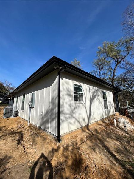 View of side of home with central air condition unit