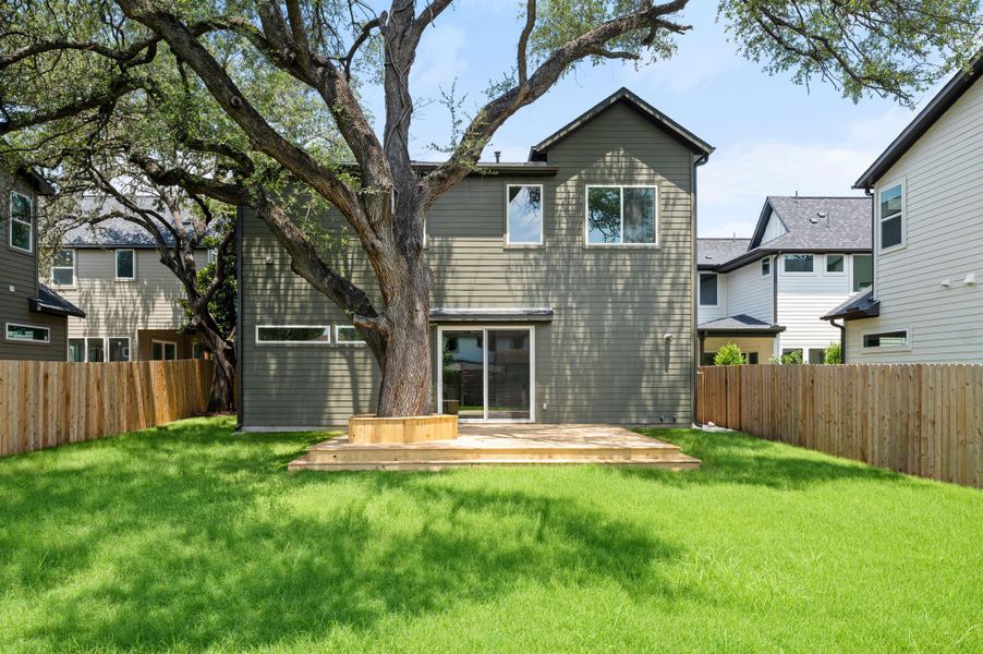 A tranquil backyard setting features a spacious deck, perfect for outdoor enjoyment. A tranquil backyard setting features a spacious deck, perfect for outdoor enjoyment.