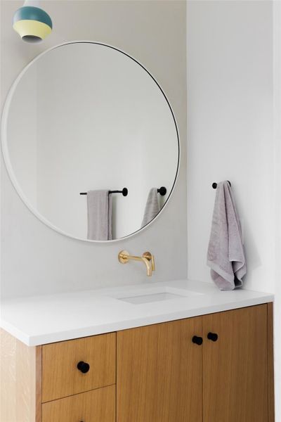 Gorgeous detailing adorns the guest bathroom that includes wall mounted faucet.