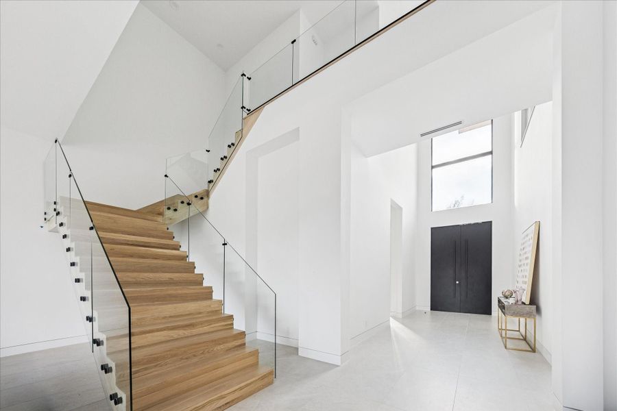 ake the sleek glass staircase with white oak floors upstairs.