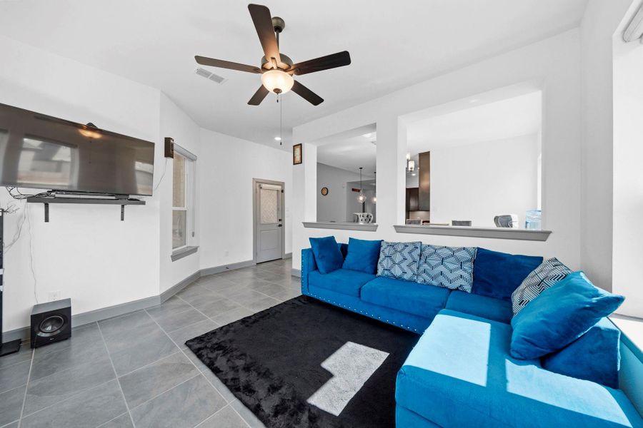 Comfortable living space featuring abundant natural light and an open flow to adjacent areas.