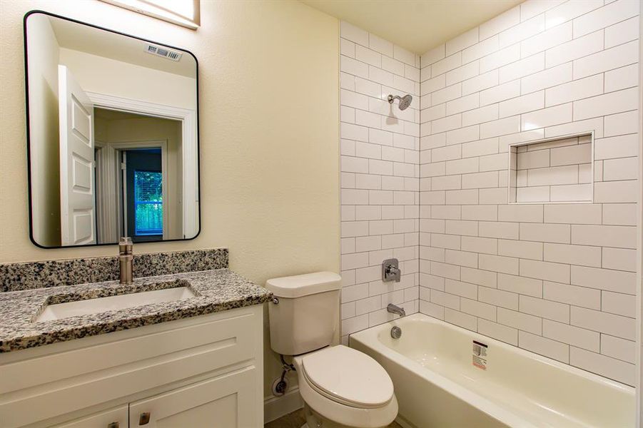 Full bathroom featuring vanity and bathtub / shower combination Full bathroom featuring vanity and bathtub / shower combination