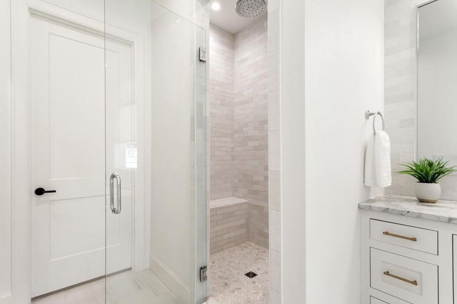 Bathroom featuring a stall shower and baseboards