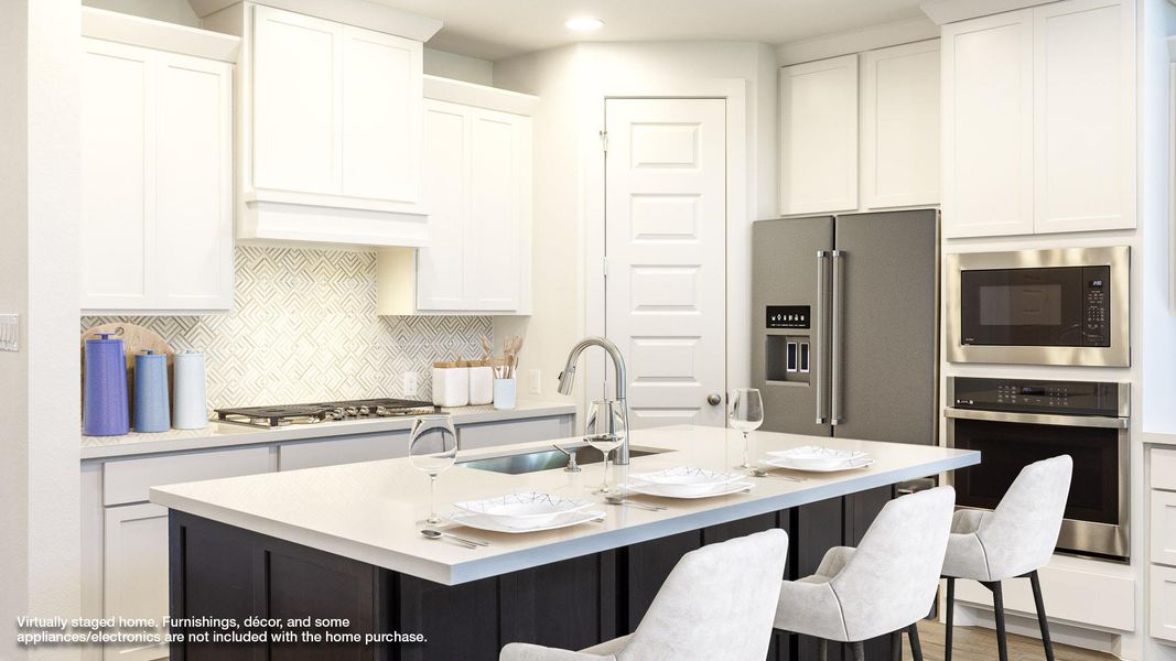 Kitchen featuring a sink, stainless steel appliances, decorative backsplash, a kitchen bar, and white cabinets Kitchen featuring a sink, stainless steel appliances, decorative backsplash, a kitchen bar, and white cabinets