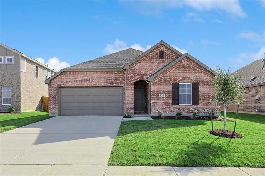 View of front of property with a front yard and a garage