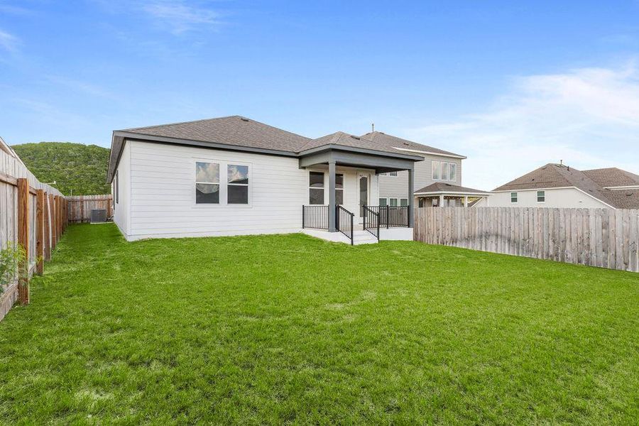 A generous lawn with a fenced perimeter surrounds this contemporary home's covered patio. A generous lawn with a fenced perimeter surrounds this contemporary home's covered patio.