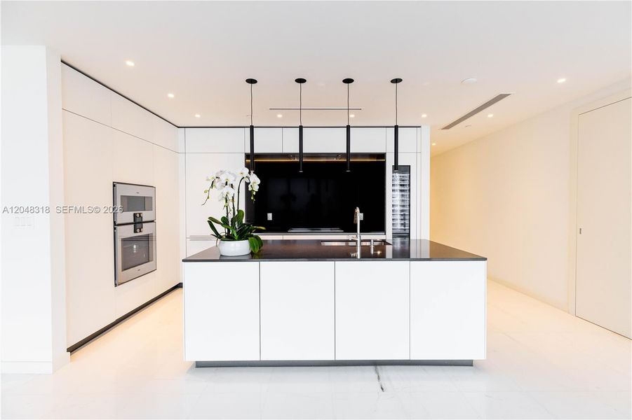an open chef’s kitchen with custom Bulthaup cabinetry and top-of-the-line Gaggenau appliances is complemented by solid-core Bertolotto doors and imported Thassos. an open chef’s kitchen with custom Bulthaup cabinetry and top-of-the-line Gaggenau appliances is complemented by solid-core Bertolotto doors and imported Thassos.